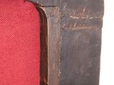 a close up of a red chair with a black frame