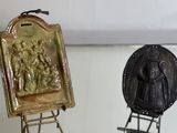 two metal objects that are on display in a glass case