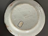 a white plate with a small hole in the middle of it