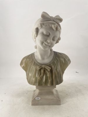a white marble bust of a woman with a bow on her head