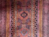 a close up of a rug on a wooden floor