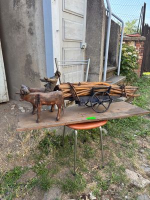 a wooden cart with a horse and a dog on it