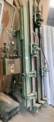 a machine that is sitting next to a pile of sheets of paper