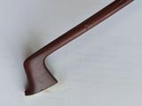 a close up of a wooden handle on a white surface