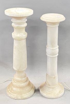 pair of white marble candlesticks on a gray background