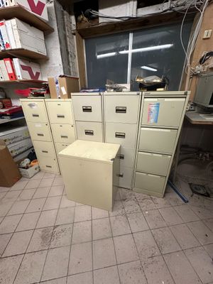 a lot of filing cabinets in a room with a lot of boxes on the floor