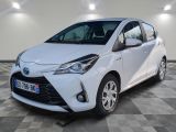 a white toyota yaris parked on a checkered floor