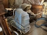 a baby stroller in the middle of a dirty room