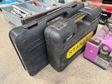 several pieces of luggage sitting on the ground next to a tool box