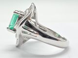 an image of a ring with an emerald stone