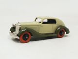 a green toy car with red wheels on a white surface