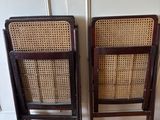 two wooden chairs sitting next to each other on top of a hard wood floor
