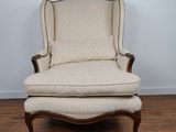 a chair and ottoman in a room with wood floors