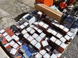 a pile of boxes of cigarettes sitting on the ground