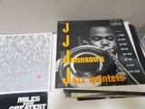 a lot of records on a table with a trumpet