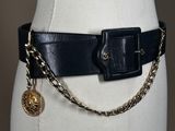 a close up of a mannequin torso with a chain belt