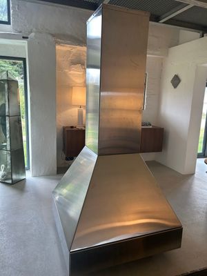 a large stainless steel stove in the middle of a room