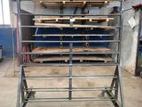 a metal rack with several shelves on it in a warehouse