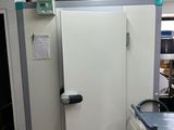 an image of a room with a refrigerator and a table