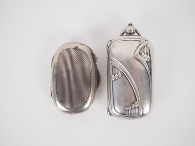 silver plated pill case and a silver pill case on a white surface