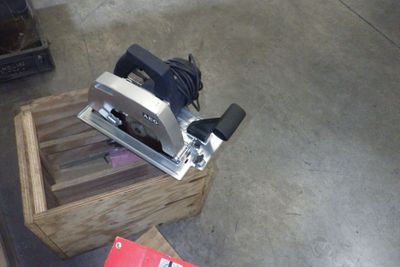 someone is using a planer to cut a piece of wood on a table