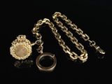 a close up of a necklace and a ring on a black surface