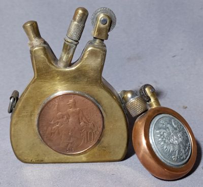 a coin and a lighter sitting next to each other on a table