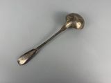 silver spoon with a long handle on a white surface