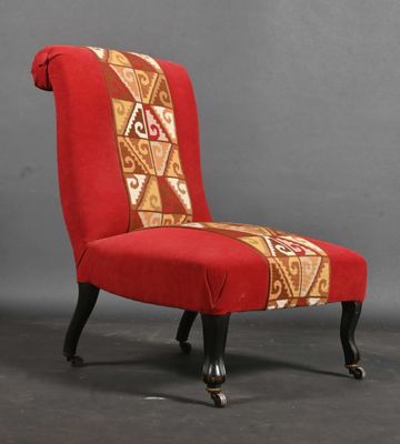 an image of a red chair with a patterned seat and legs
