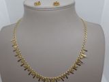 a close up of a necklace and earrings on a mannequin