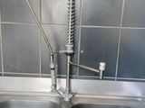 a kitchen sink with a faucet and a faucet in it