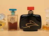 three bottles of perfume sitting next to each other on a table