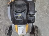 a picture of a lawn mower that is sitting on the ground