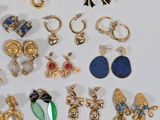 a lot of earrings that are sitting on a table