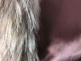 a close up of a woman wearing a fur coat