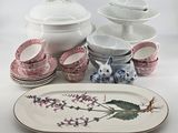 a lot of plates and bowls that are on the table