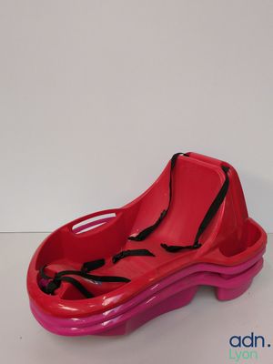pink plastic shoe shaped toy with a black bow on the side