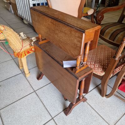 a rocking horse that is next to a table and chair