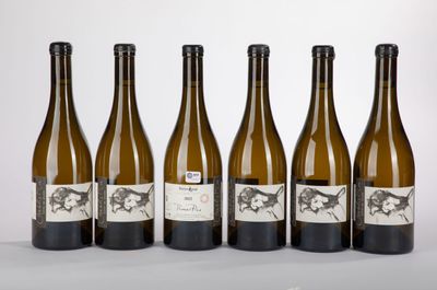 six bottles of wine are lined up on a table