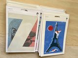 three folders with a picture of a man playing tennis on them