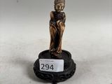 an image of a small statue of a person sitting on a pedestal