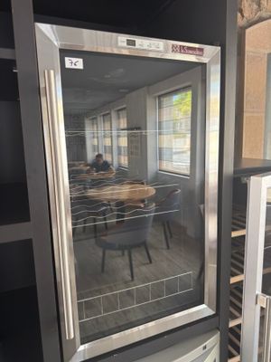 an image of a glass door refrigerator in a kitchen