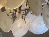 many white plates hanging from the ceiling of a restaurant