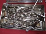 a box of surgical tools on a red table