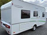 an image of a white camper parked in a parking lot