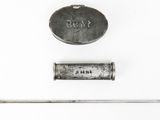 a small metal object that is laying on a white surface