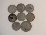a lot of coins sitting on a white surface