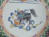 a plate with a picture of a man riding a horse on it