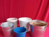 several buckets of coffee are lined up on a red table