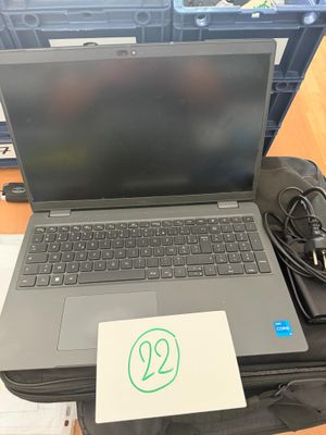 a laptop computer sitting on top of a piece of luggage